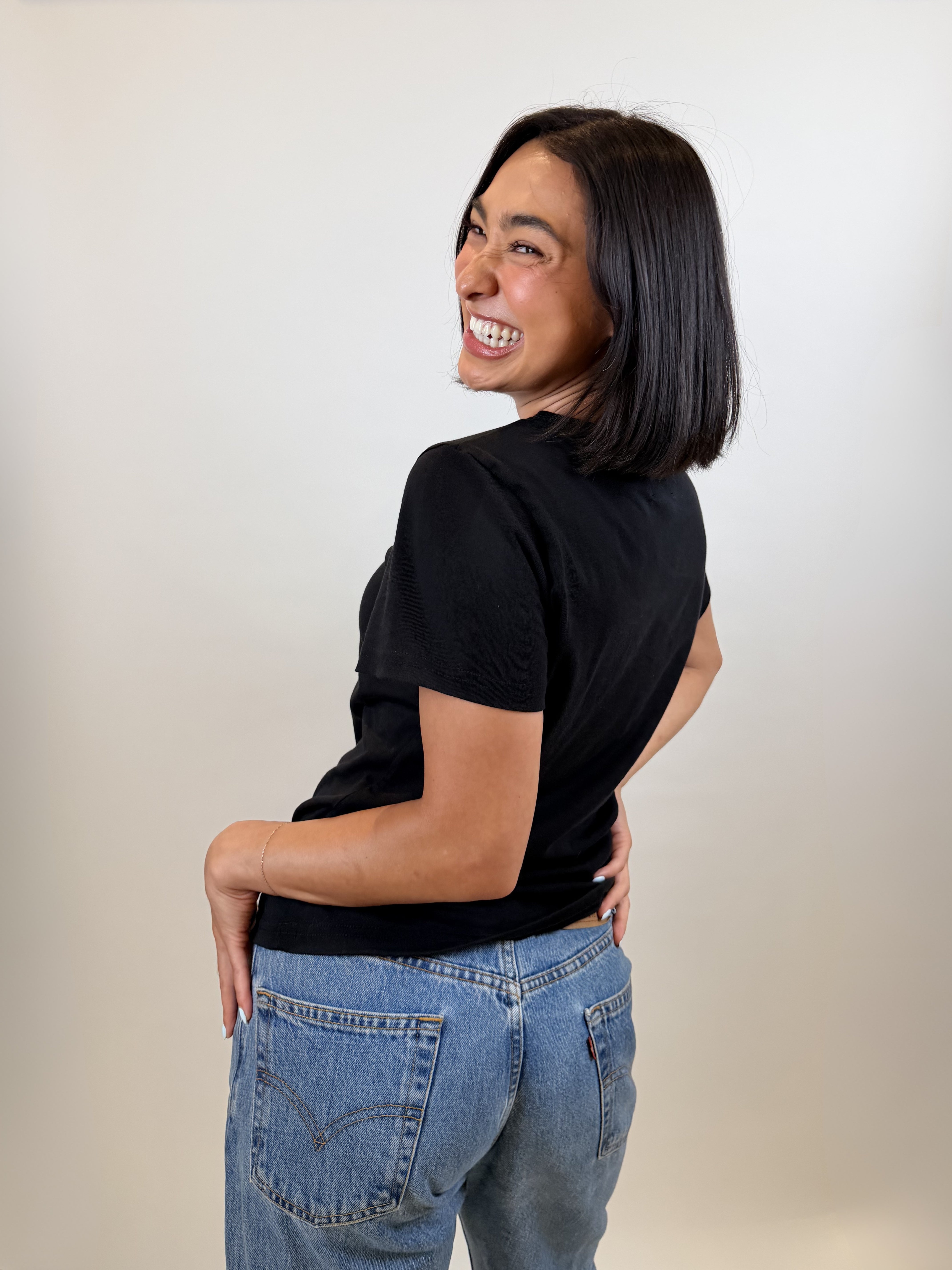 The Shortie Sleeve Tee in black, side view