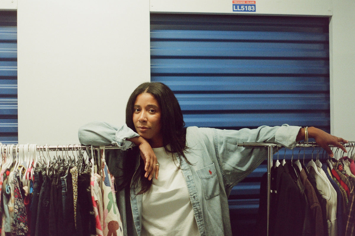 Bria Parrish in the Still Good storage center among racks of donated merchandise